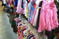 Rack with dresses and infant tops